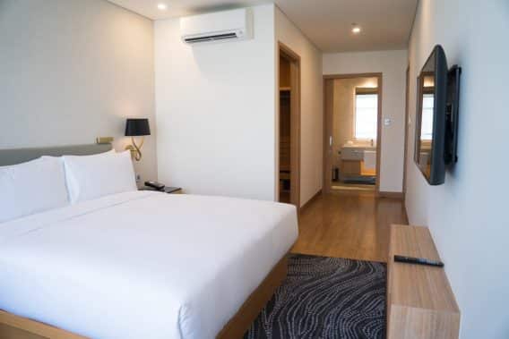small hotel room interior with double bed bathroom